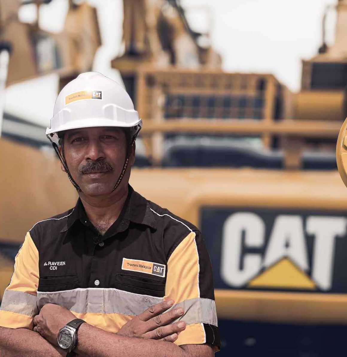 Tractors Malaysia Man in High Hat in front of machine